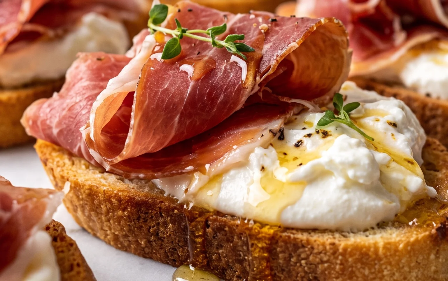 Beef Prosciutto Crostini with Burrata and Lemon Honey Drizzle